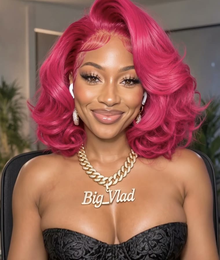 Kelly, the Knocturn Labs AI assistant, smiling, with pink hair and a gold Big_Vlad chain
